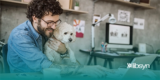 Man holding a cute dog and pointing to his laptop while researching the best Podcast name